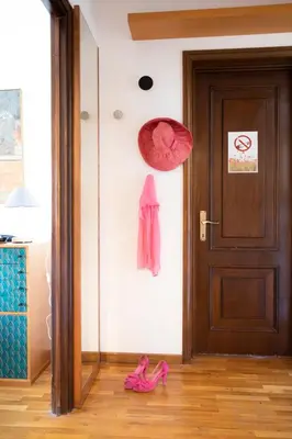 a pair of pink slippers on the floor next to a door at Eva's house Roma in Rome