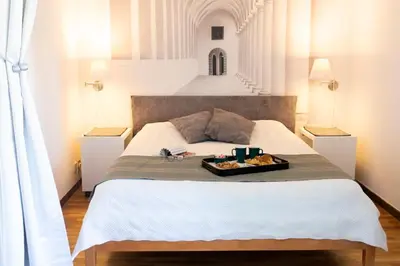 a bed with a tray of food on top of it at Eva's house Roma in Rome