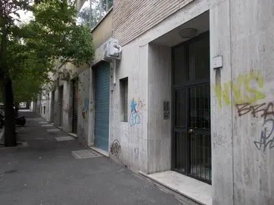 an alley with graffiti on the side of a building at Milla's house rome in Rome