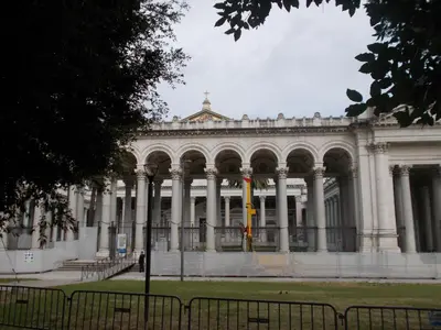 a large white building with columns in a park at Milla's house rome in Rome