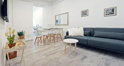 a living room with a blue couch and a table at Pompeo Magno White Luxury Apartment in Rome