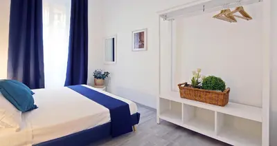 a white bedroom with a bed and a window at Pompeo Magno White Luxury Apartment in Rome