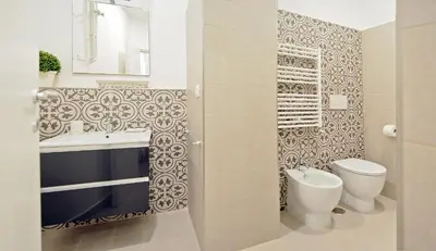 a bathroom with a toilet and a sink at Pompeo Magno White Luxury Apartment in Rome