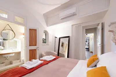a bedroom with a large bed with two towels at Rome As You Feel - Cancelli Apartment in Rome