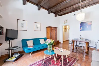 a living room with a blue couch and a table at Rome As You Feel - Cancelli Apartment in Rome
