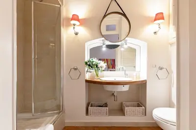 a bathroom with a sink and a shower and a mirror at Rome As You Feel - Cancelli Apartment in Rome