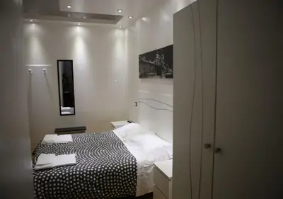 a small bedroom with a black and white bed at Vatican Room and Kitchen in Rome