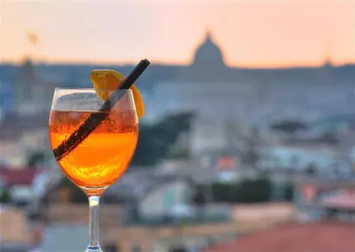 a drink with a slice of lime in a glass at Vatican Room and Kitchen in Rome