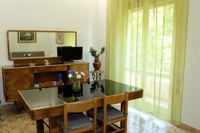 a dining room with a glass table and a mirror at CASA ARIEL in Rome
