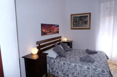 a bedroom with a bed with pillows on it at CASA ARIEL in Rome