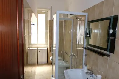 a bathroom with a sink and a toilet and a mirror at CASA ARIEL in Rome