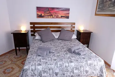 a bedroom with a large bed with two night stands at CASA ARIEL in Rome