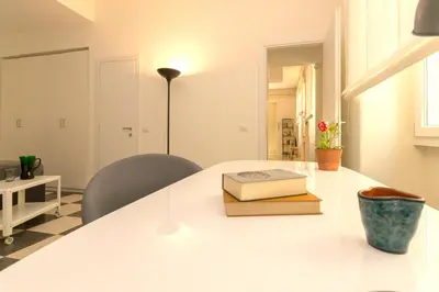 a white table with a book on top of it at Virgiliano Apartment in Rome