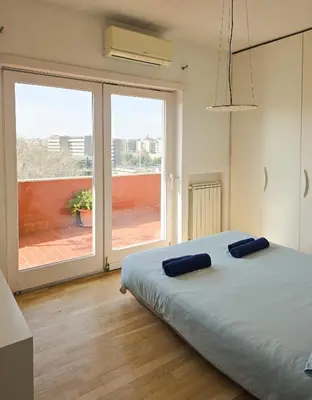 a bedroom with a bed and a large window at Panoramic Sunset Terrace Attic in Rome