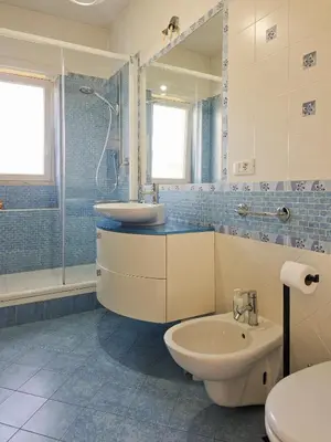 a bathroom with a sink and a toilet and a shower at Panoramic Sunset Terrace Attic in Rome