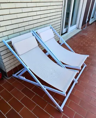 two folding chairs sitting on a brick patio at Panoramic Sunset Terrace Attic in Rome