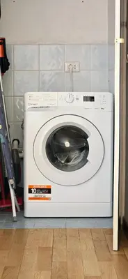 a white washing machine sitting in a kitchen at Panoramic Sunset Terrace Attic in Rome