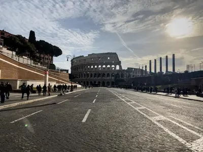 a group of people walking down a city street at COLOSSEUM STREET HoMe in Rome