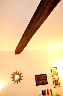 a ceiling with a beam and a clock on a wall at Roman Atmospheres in Rome