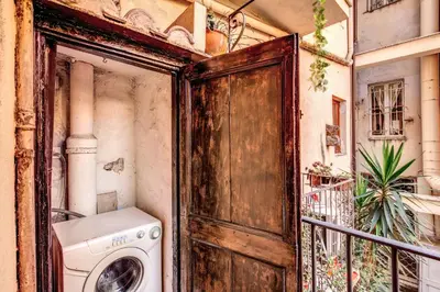 a washer and dryer in a room with a door at Roman Atmospheres in Rome