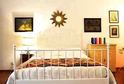 a bedroom with a white bed and a mirror on the wall at Roman Atmospheres in Rome