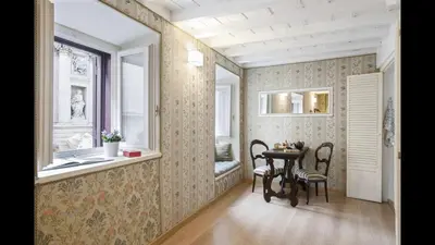 a kitchen and a dining room with a table at Panoramic Trevi Fountain View Luxury Apt in Rome