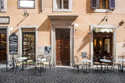 a group of tables and chairs in front of a building at Panoramic Trevi Fountain View Luxury Apt in Rome