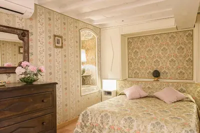 a dining room with a table and chairs and a window at Panoramic Trevi Fountain View Luxury Apt in Rome