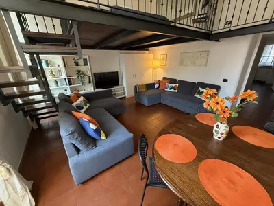 a living room with a couch and a table and chairs at ROME LUXURY HOUSE - THE SUITE in Rome