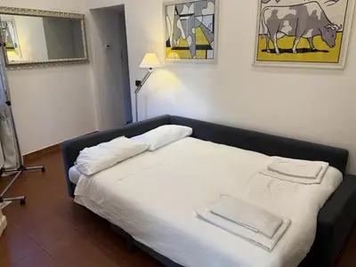 a bedroom with a bed with two towels on it at ROME LUXURY HOUSE - THE SUITE in Rome