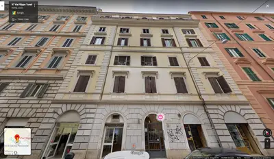 a large building with windows on a city street at Domus Termini in Rome