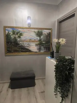 a painting on a wall with a bench in a room at Napoleone Luxury Home roma in Rome
