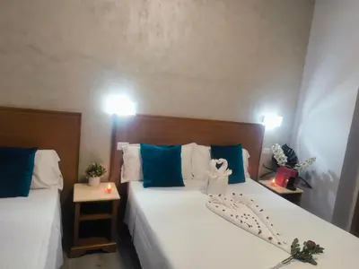 a bedroom with two beds with blue and white pillows at Napoleone Luxury Home roma in Rome