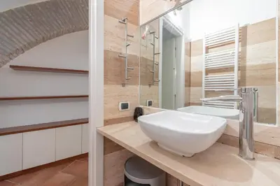 a bathroom with a sink and a shower at Roman Forum Cozy Apartment in Rome
