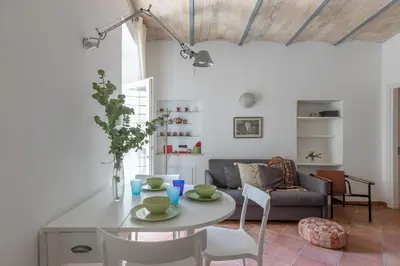 a living room with a table and a couch at Roman Forum Cozy Apartment in Rome