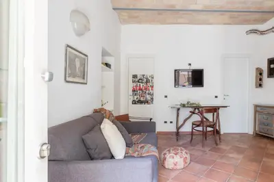 a living room with a couch and a table at Roman Forum Cozy Apartment in Rome