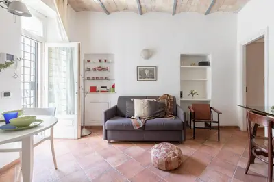 a living room with a couch and a table at Roman Forum Cozy Apartment in Rome
