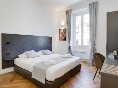 a bedroom with a large bed and a desk at The Right Place - Guest House in Rome