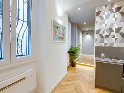 a hallway with white walls and a staircase with a window at The Right Place - Guest House in Rome