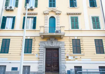 a building with a wooden door and a balcony at The Right Place - Guest House in Rome