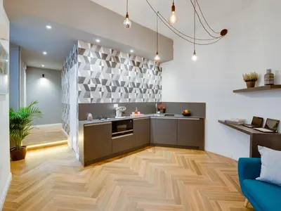 a kitchen with wooden floors and a blue couch at The Right Place - Guest House in Rome