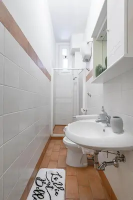 a bathroom with a sink and a toilet at Riari 59 Rome Trastevere - Rome Vacation M&D in Rome