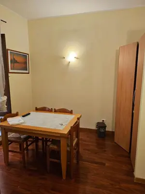 a dining room with a table and chairs in a room at Aida Trevi Fountain Rome in Rome