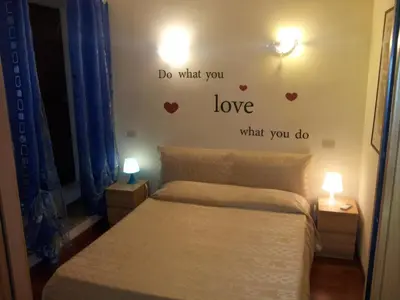 a bedroom with a bed with hearts on the wall at Aida Trevi Fountain Rome in Rome
