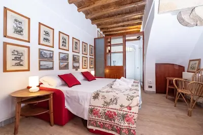 a bedroom with a large bed with red pillows at Campo de' Fiori Cozy Nest in Rome