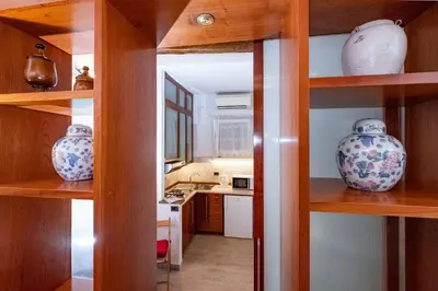 a kitchen with wooden shelves with vases on them at Campo de' Fiori Cozy Nest in Rome
