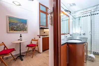 a kitchen with a sink and a table and chairs at Campo de' Fiori Cozy Nest in Rome