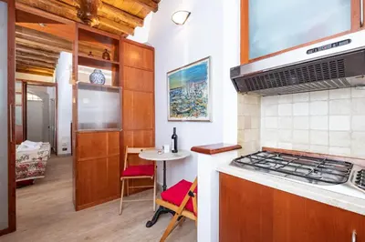 a kitchen with a stove top oven next to a table at Campo de' Fiori Cozy Nest in Rome