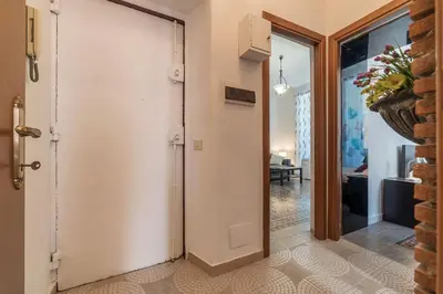 a door leading to a hallway with a living room at GuestHost - Borgo Pio Elegant Apartment! in Rome
