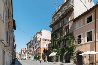 an empty street with buildings and an umbrella at GuestHost - Borgo Pio Elegant Apartment! in Rome